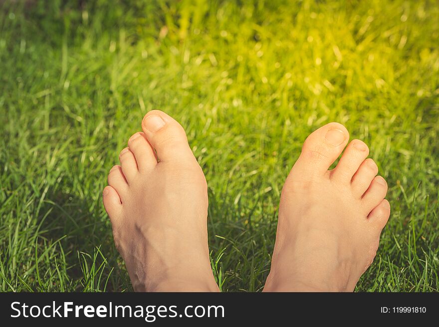 Close Up Of Woman Feet On The Green Grass