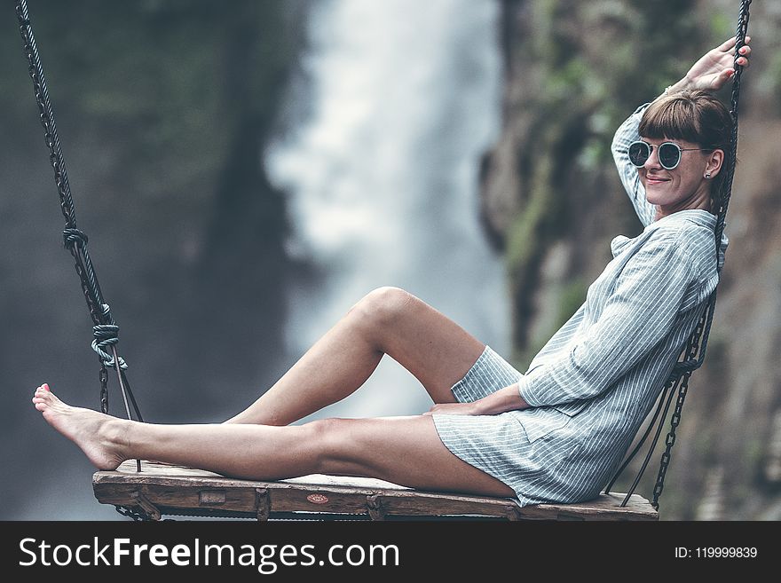 Woman Sitting On Swing