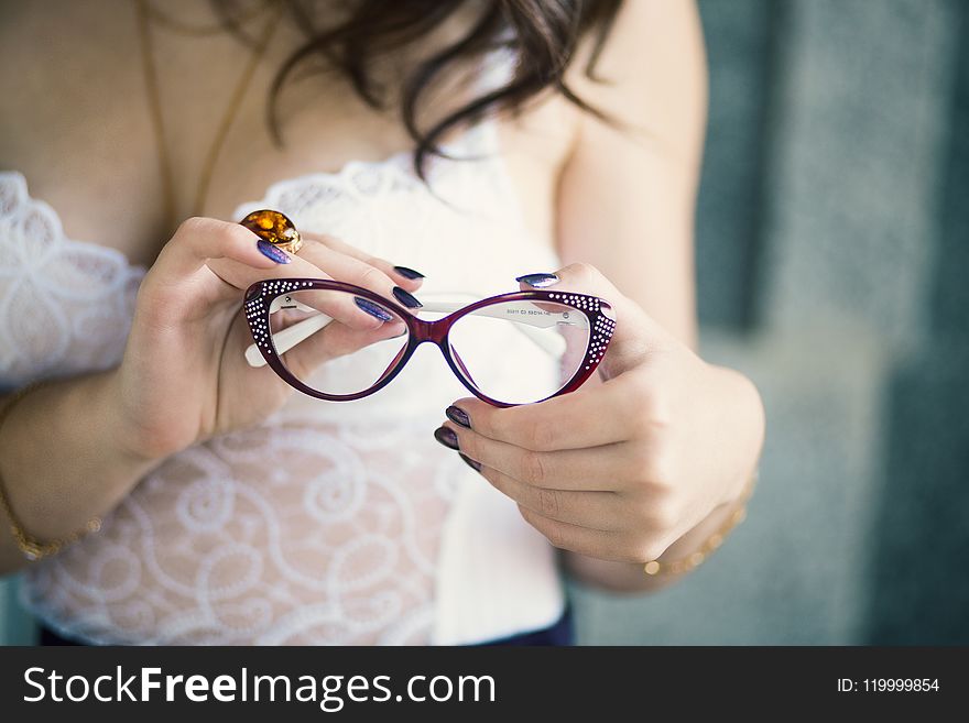 Closeup Photo of Person Holding Eyeglasses