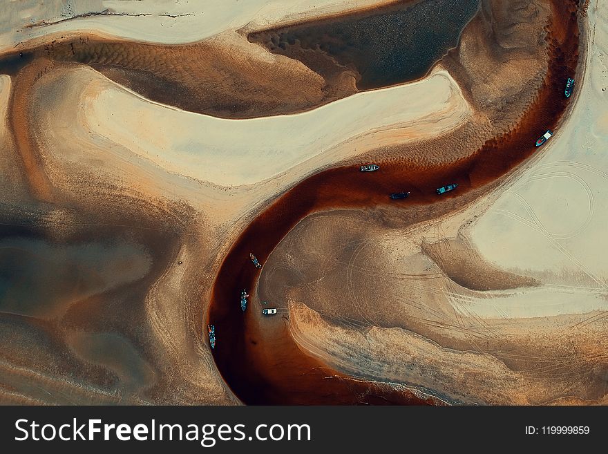 Aerial-photography Of Boats On River Surrounded By Desert