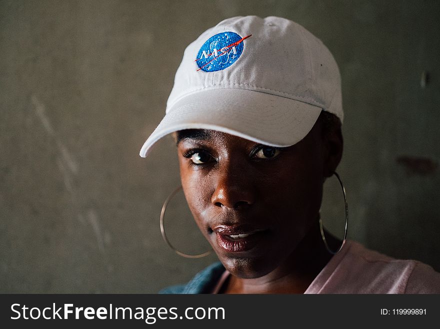 Woman Wearing Hoop Earrings and Nasa Baseball Cap