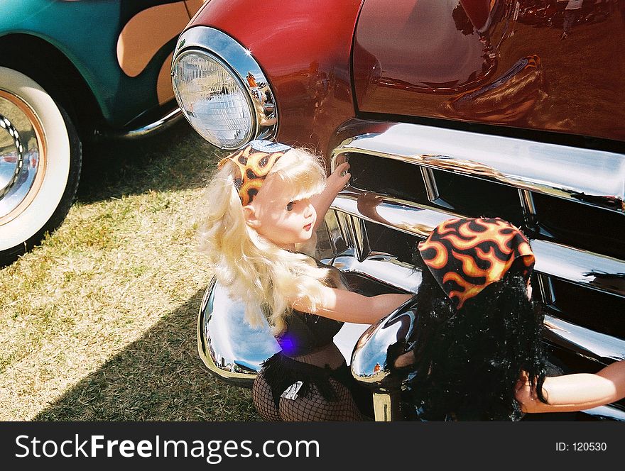 Lovely dolls pushing vintage car. Lovely dolls pushing vintage car