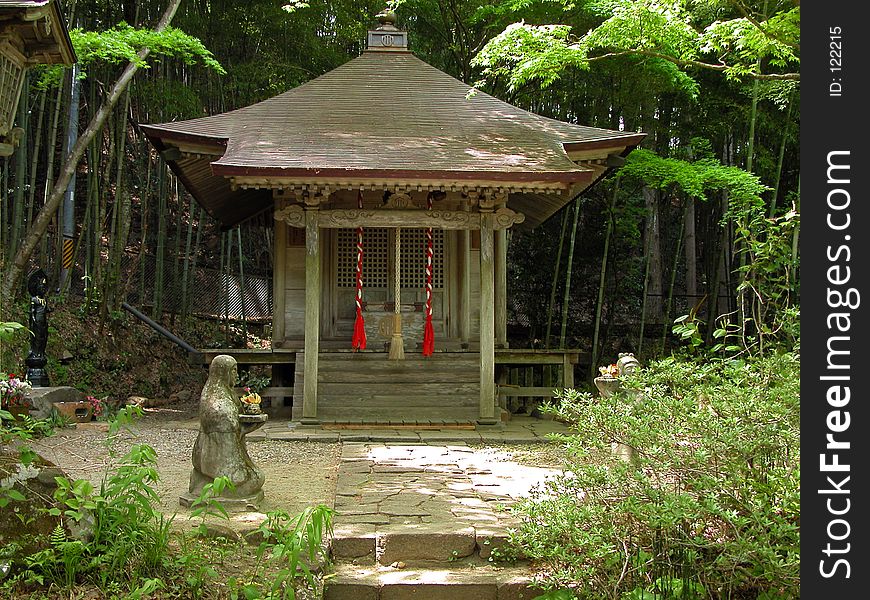 A wooden shrine in a wild forest. A wooden shrine in a wild forest
