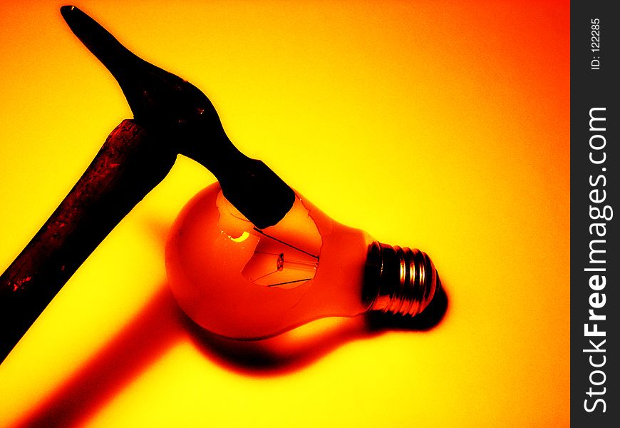 This is a conceptual image of a hammer breaking a lightbulb. This is a conceptual image of a hammer breaking a lightbulb.