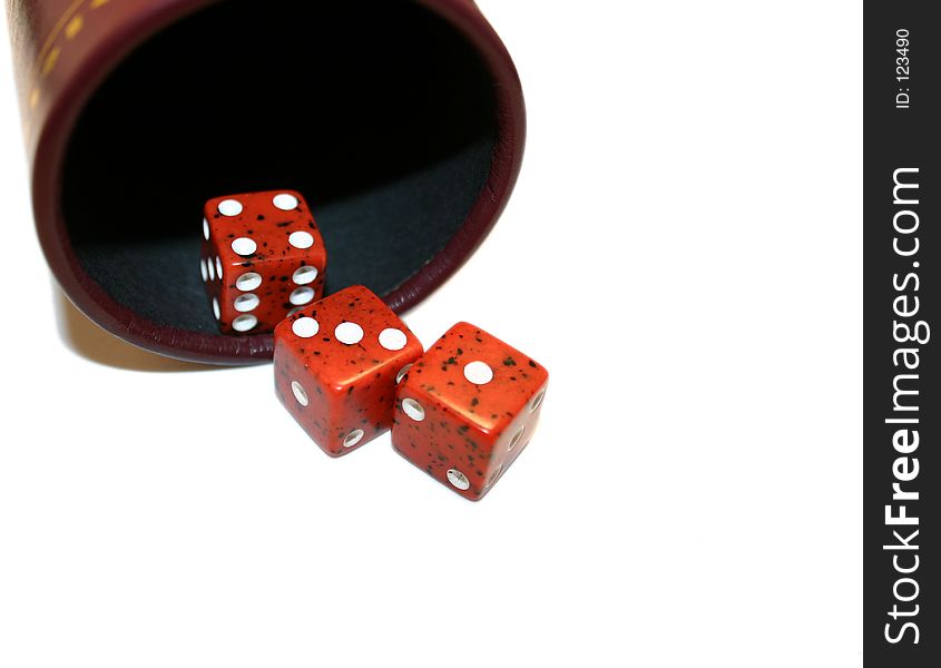 3 red dice spilling out of a tumbler