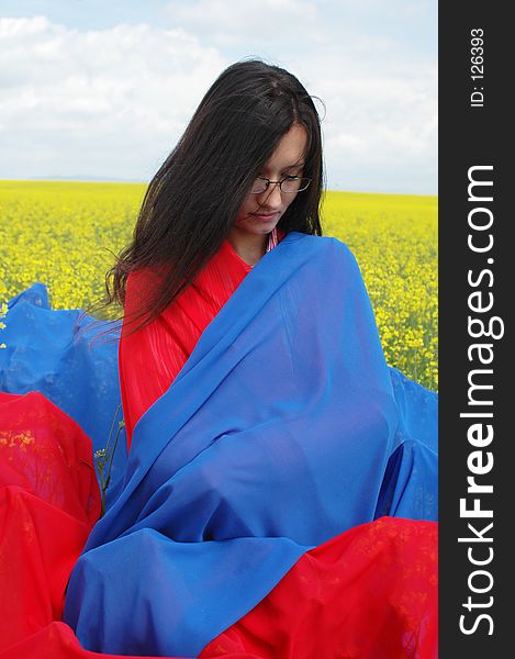 Woman meditating in the middle of nature. red and blue scarfs are helping. Woman meditating in the middle of nature. red and blue scarfs are helping.