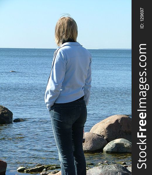 Woman standing on a rocky beach