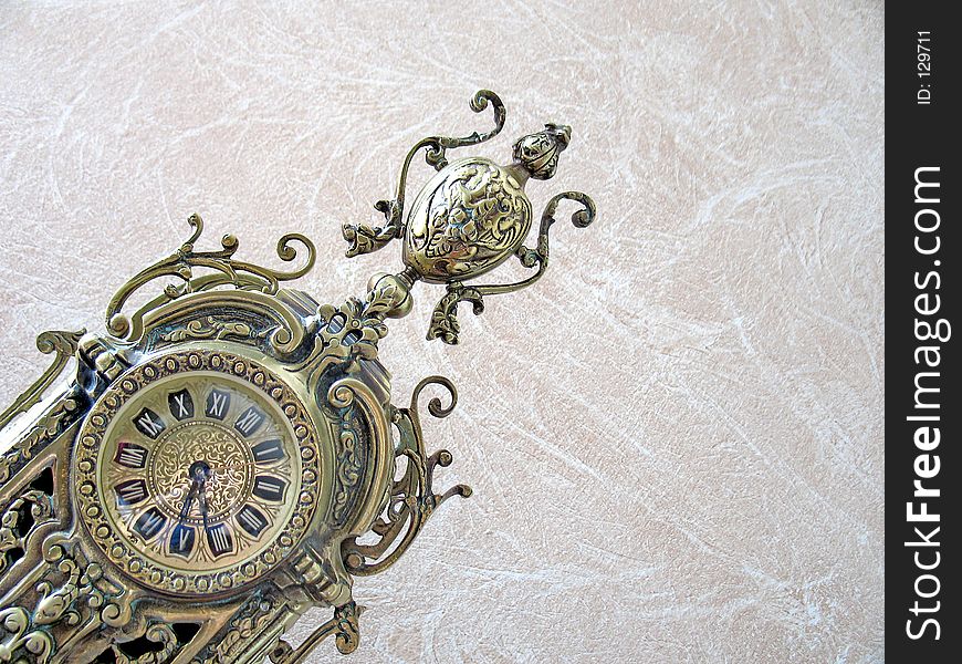 An antique bronze clock - leaning shot. An antique bronze clock - leaning shot