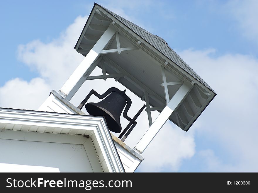 A church bell on the top of a roof