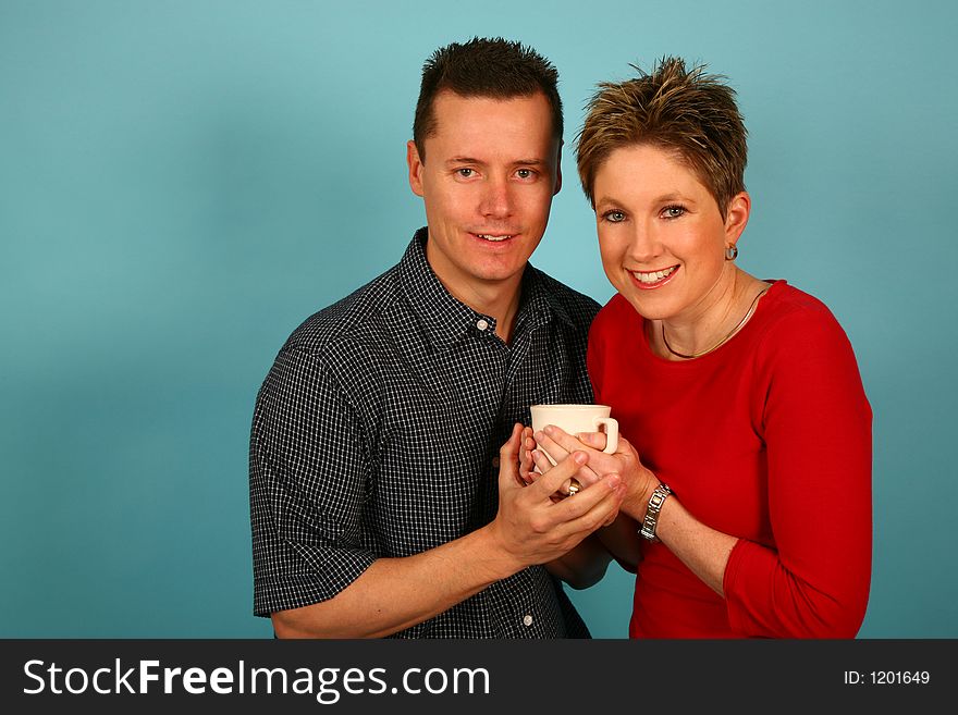 Couple holding coffee mug together