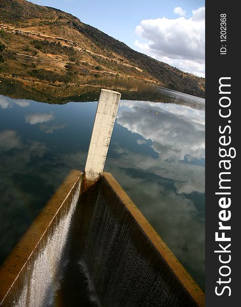 Riverbank and clouds reflecting on water. Riverbank and clouds reflecting on water