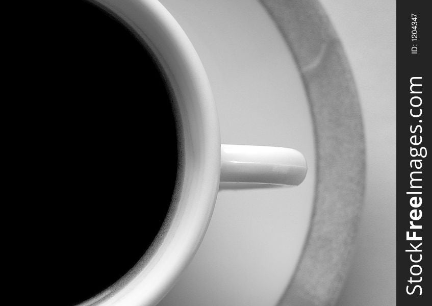 Black and white photo of a cup of black cofee. Abstract close-up. Black and white photo of a cup of black cofee. Abstract close-up.