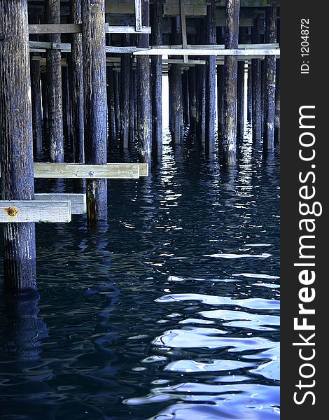 A structure built on posts extending from land out over water, used as a landing place for ships, an entertainment area, a strolling place. A structure built on posts extending from land out over water, used as a landing place for ships, an entertainment area, a strolling place