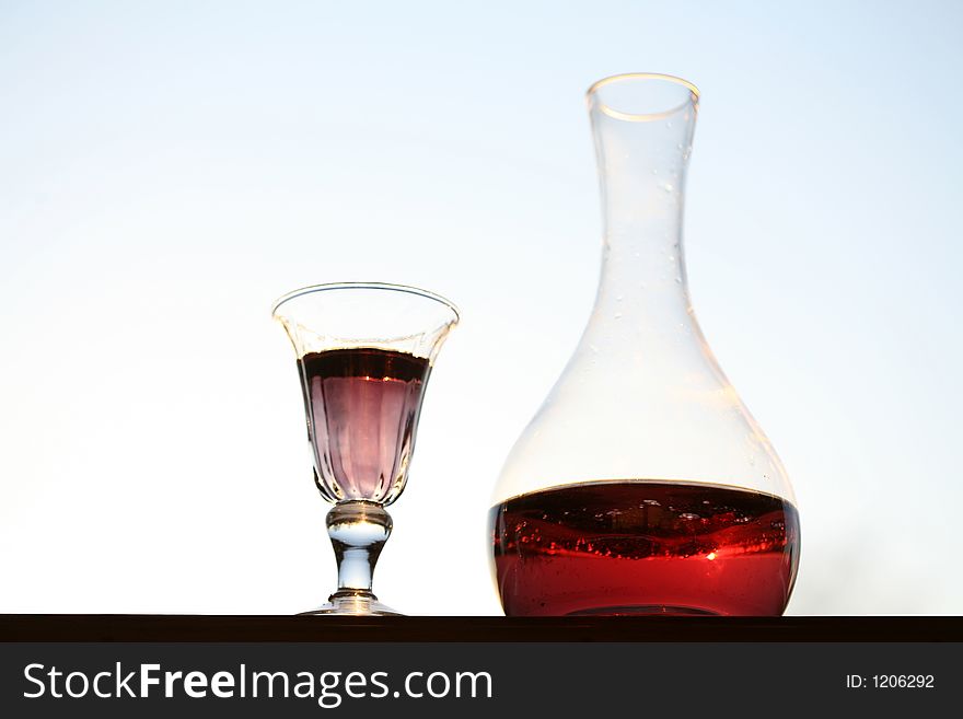 Wine glass and  bottle with light blue background