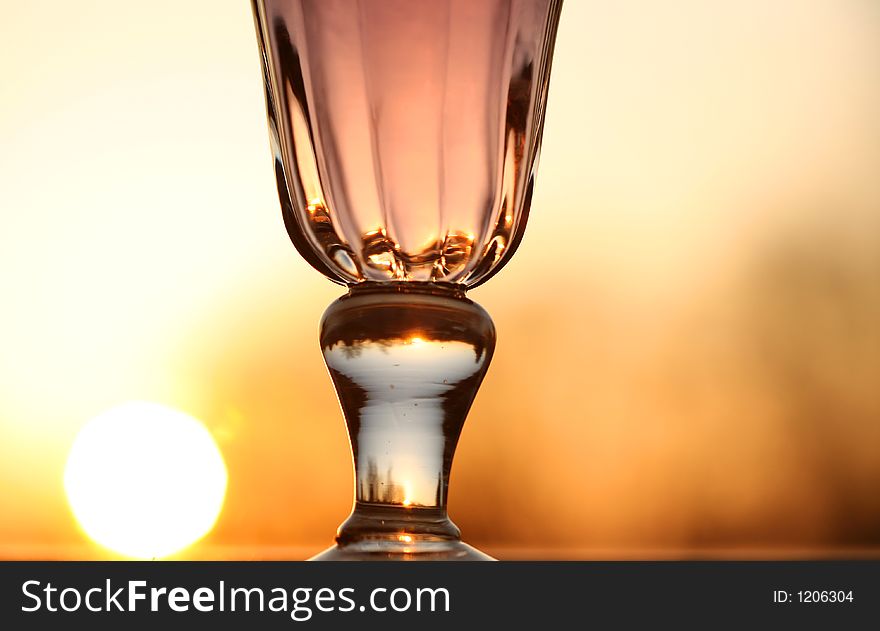 Wine glass with orange background (sunset)