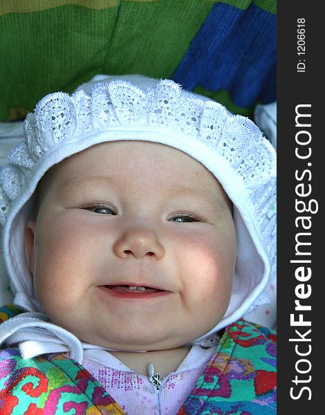 A baby girl showing her first milk teeth. A baby girl showing her first milk teeth