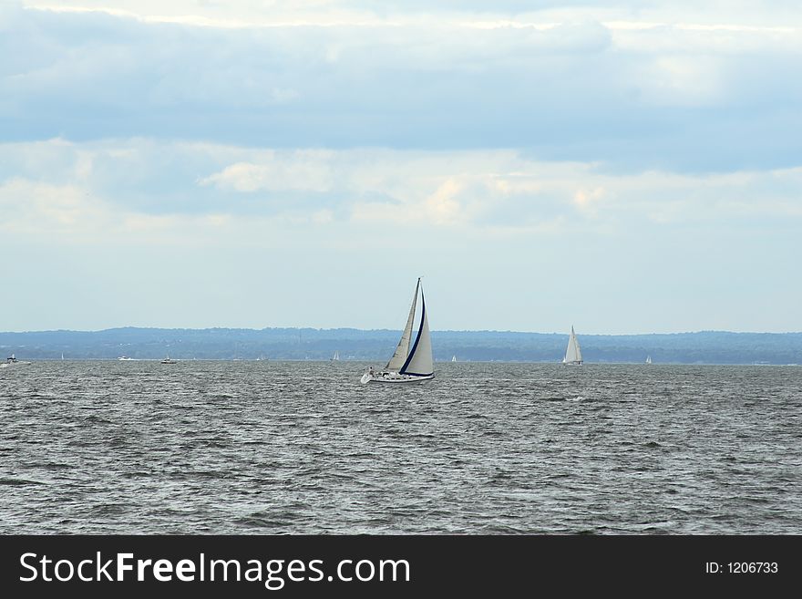 Sailboat beating into the wind on a stormy day. Sailboat beating into the wind on a stormy day.