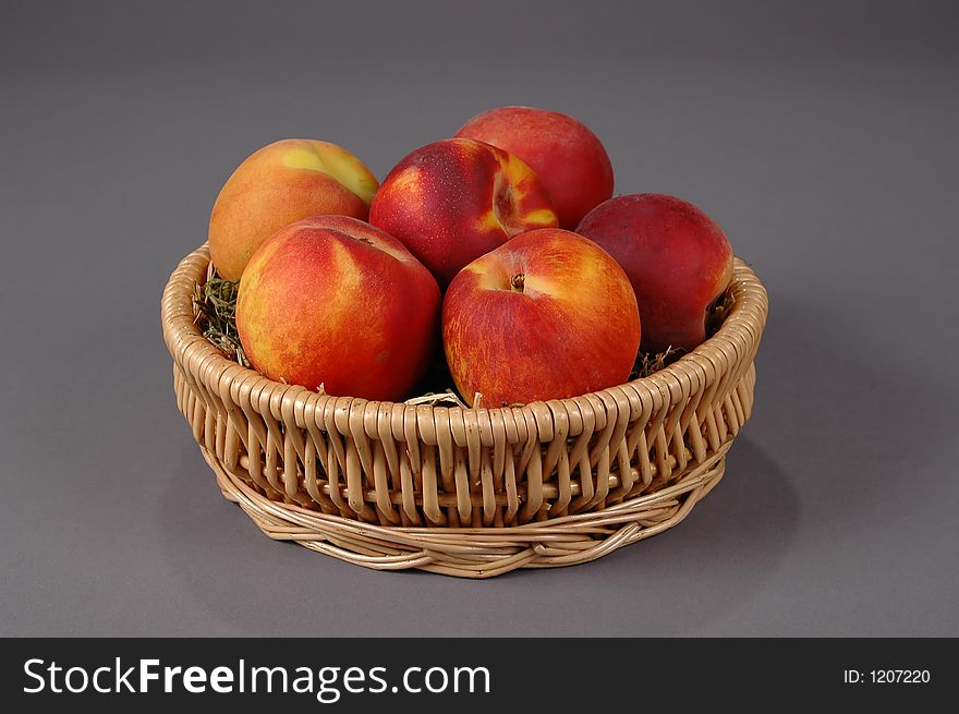 Fresh and colorful peaches on a neutral background. Fresh and colorful peaches on a neutral background