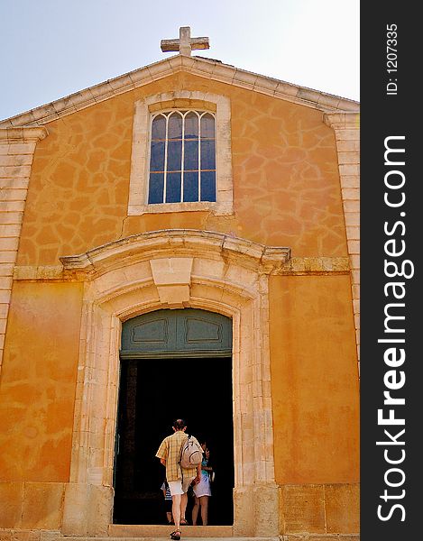 The church at the village of Rossillion in France, with its ochre tinted walls. The church at the village of Rossillion in France, with its ochre tinted walls