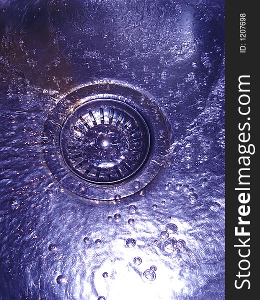 Flowing water in sink with bubbles