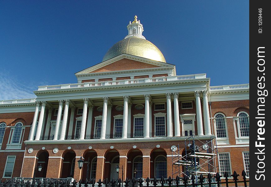 Showing Beacon street and the Massachusetts State House with a deep blue sky. Showing Beacon street and the Massachusetts State House with a deep blue sky