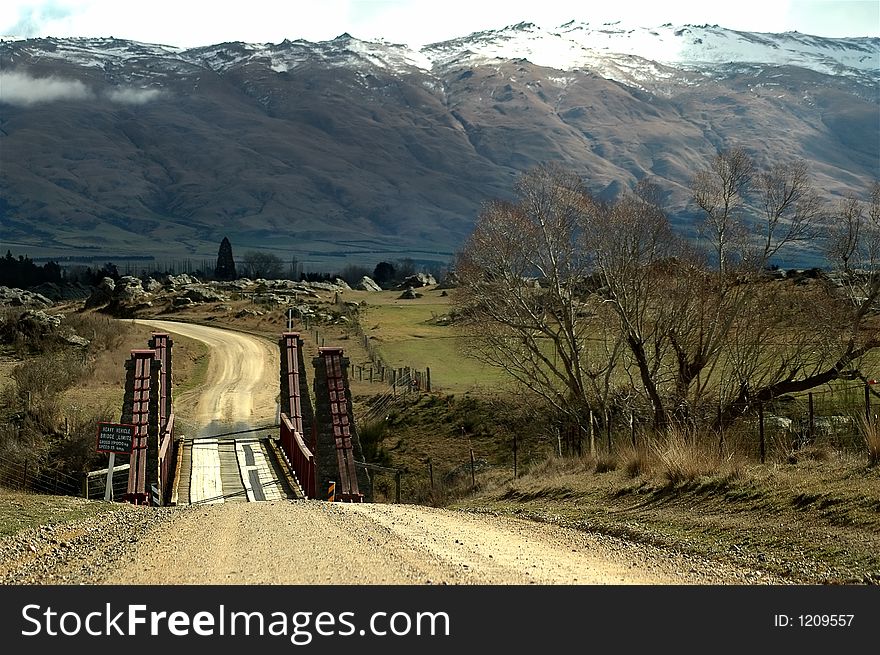 Snow covered hills with country road and bridge. Snow covered hills with country road and bridge