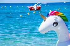 Unicorn Swim Tube On The Beach On Sea Background. Inflatable Rubber Unicorn.Fantasy Swim Ring For Summer Pool Trip Or Royalty Free Stock Photo