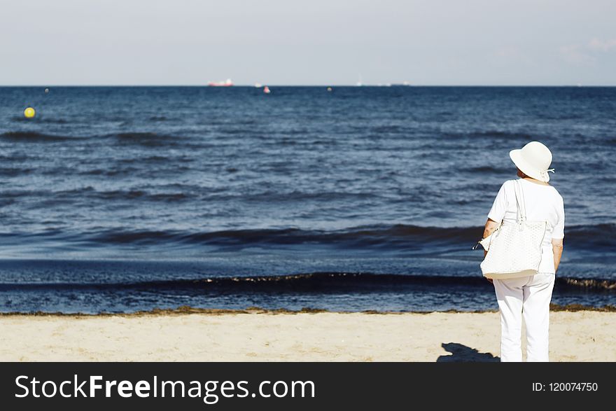 Photo of Woman Standing on Seashore