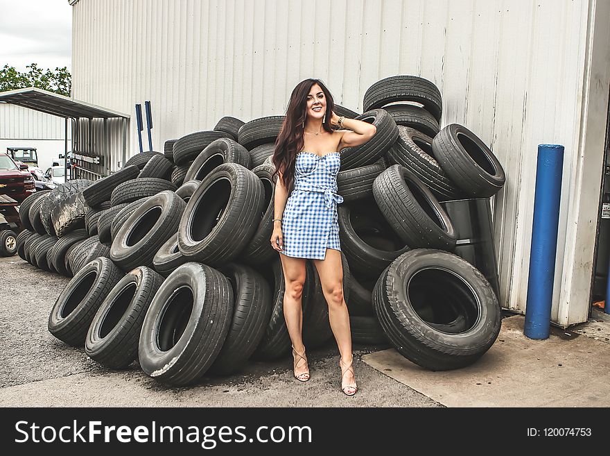 Woman posing in front of Tires