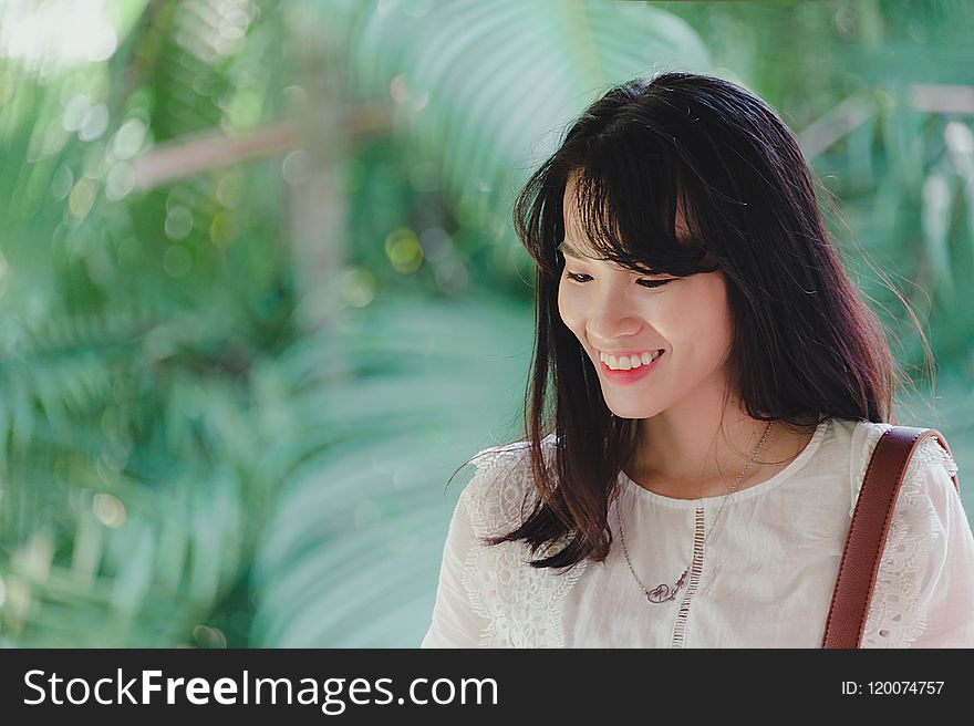 Photo of Woman Wearing White Outfit Smiling.