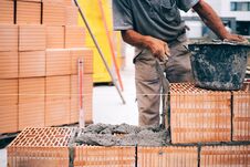 Masonry, Industrial Brick Mason, Bricklayer Working On Building Exterior Walls At Construction Site Royalty Free Stock Images