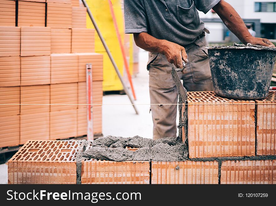 Masonry, Industrial Brick Mason, Bricklayer Working On Building Exterior Walls At Construction Site