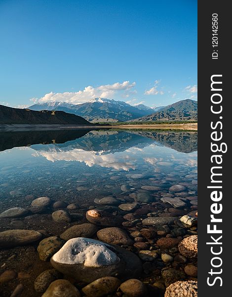 Landscape Photography of Body of Water Near Mountains