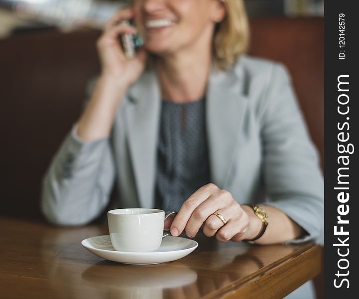 Shallow Focus Photography of Smiling Woman Holding White Cup