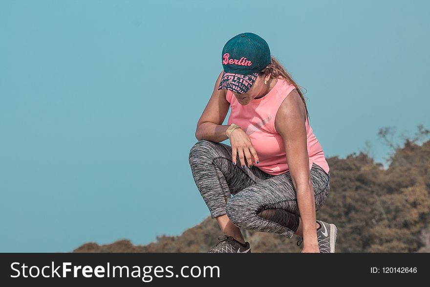 Woman Sitting On Rock