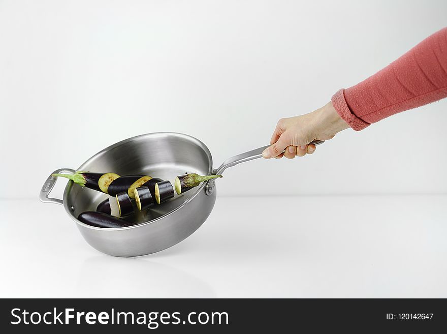Person Holding Stainless Steel Casserole