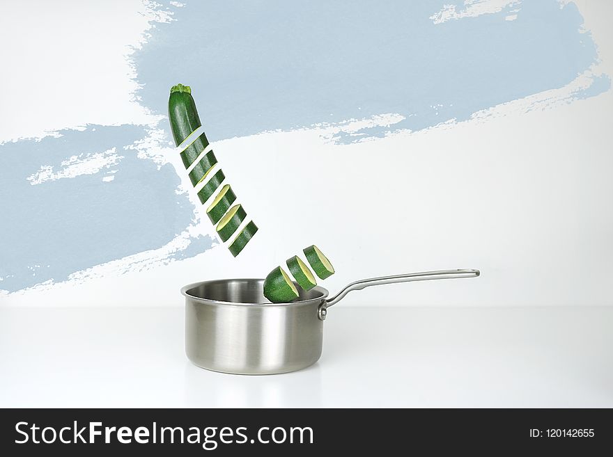 Gray Stainless Steel Sauce Pan And Green Cucumber Illustration