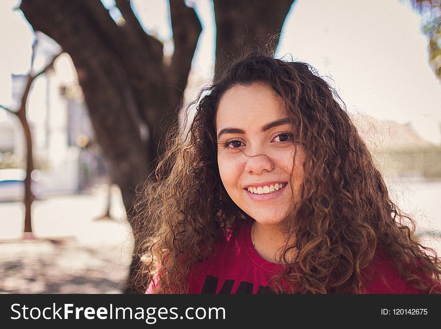 Selective Focus Photo of Woman Wearing Red and Black Crew-neck Top