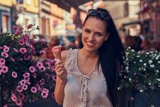 Free Happy Beautiful Brunette Girl Wearing Trendy Clothes Is Enjoying Summer Day Holds A Strawberry Ice Cream While Stands Stock Photo - 120331830