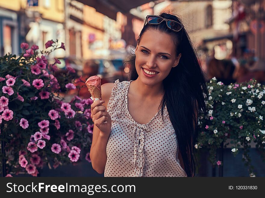 Happy Beautiful Brunette Girl Wearing Trendy Clothes Is Enjoying Summer Day Holds A Strawberry Ice Cream While Stands