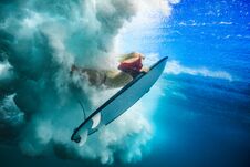 Surfer Girl Under Ocean Wave Stock Photo