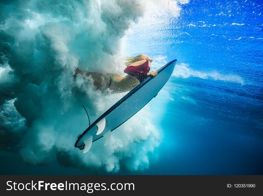 Surfer Girl Under Ocean Wave