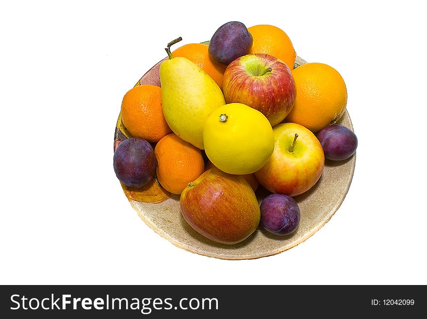 A full dish of colored fruits over white background . A full dish of colored fruits over white background