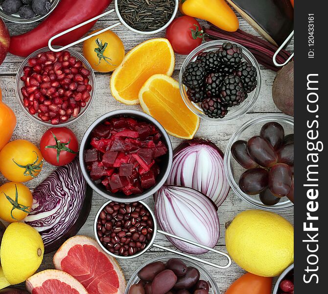 Healthy food background concept with fruit and vegetable, pulses and grain. High in antioxidants, anthocyanins and vitamins on rustic wood background. Top view. Healthy food background concept with fruit and vegetable, pulses and grain. High in antioxidants, anthocyanins and vitamins on rustic wood background. Top view.
