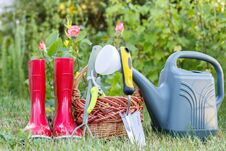 Red Garden Rubber Boots, Small Rake, Pruner, Wicker Basket, Trow Stock Photography Red Garden Rubber Boots, Small Rake, Pruner, Wicker Basket, Trow Stock Photography