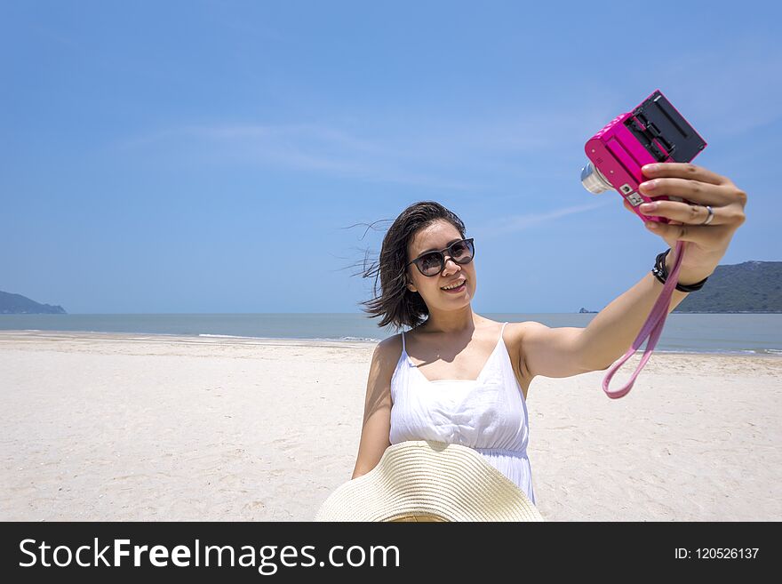 Selfie, Young Asian woman taking self portrait on the beach