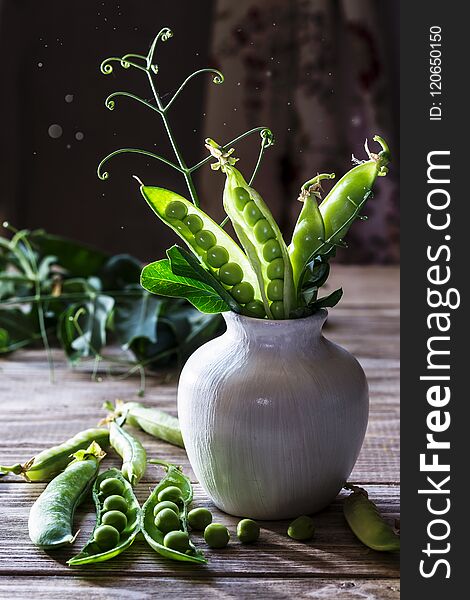 Fresh green peas on a wooden table. Fresh green peas on a wooden table.