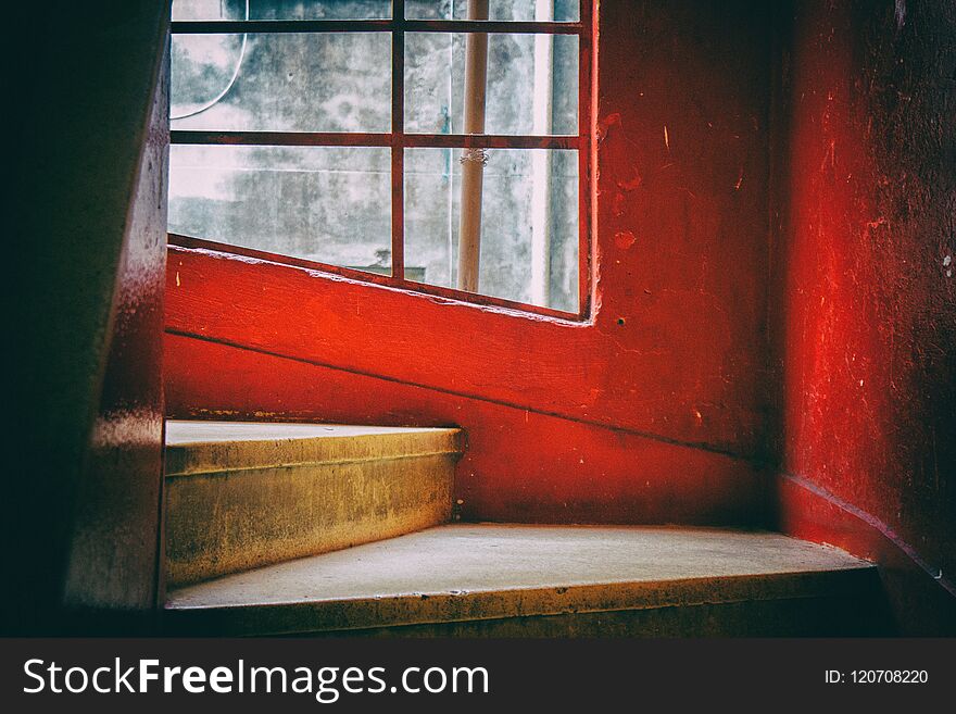 Concrete spiral staircase with red and white walls and transparent glass windows. San Paolo. Brazil. South America. No people. Concrete spiral staircase with red and white walls and transparent glass windows. San Paolo. Brazil. South America. No people.