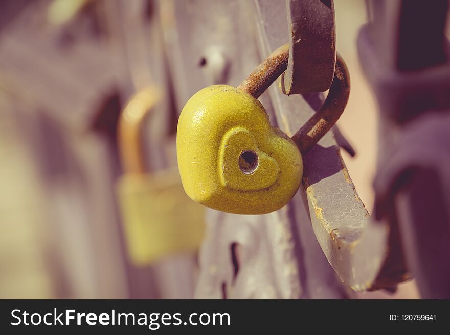 Love locks on a metal wedding bridge close up filtered background. Love locks on a metal wedding bridge close up filtered background.