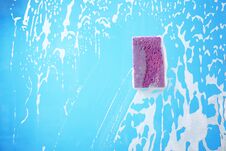 Sponge On Glass Covered With Suds Stock Photo